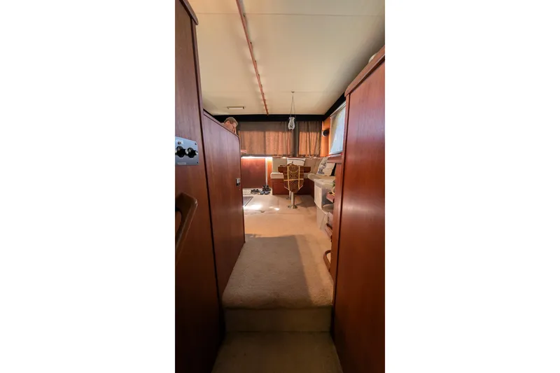 Slide: The Image of Interior of 1984 Chris-Craft 382 Commander yacht with wood paneling and carpeted flooring. - 66