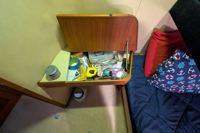 Slide: The Image of Storage compartment on 1984 Chris-Craft 382 Commander with various tools and supplies. - 78