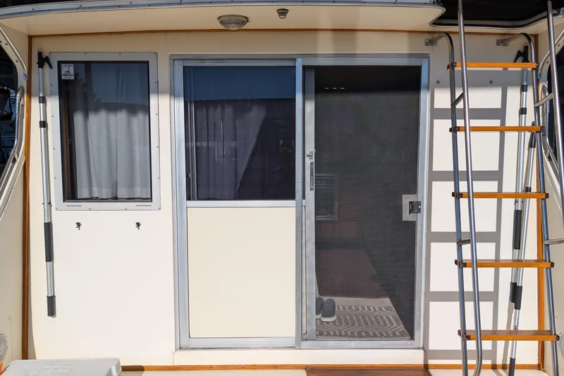 Slide: The Image of 1984 Chris-Craft 382 Commander boat with sliding door and ladder. - 8