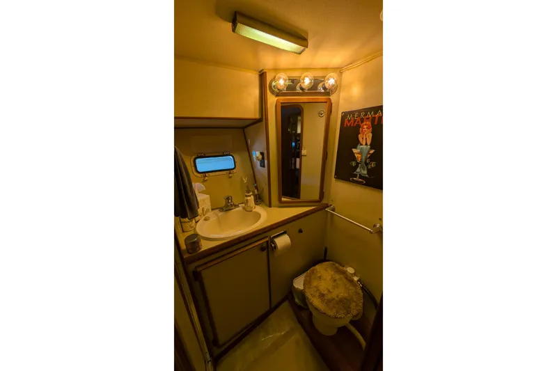 Slide: The Image of 1984 Chris-Craft 382 Commander bathroom with sink, mirror, and vintage decor. - 81
