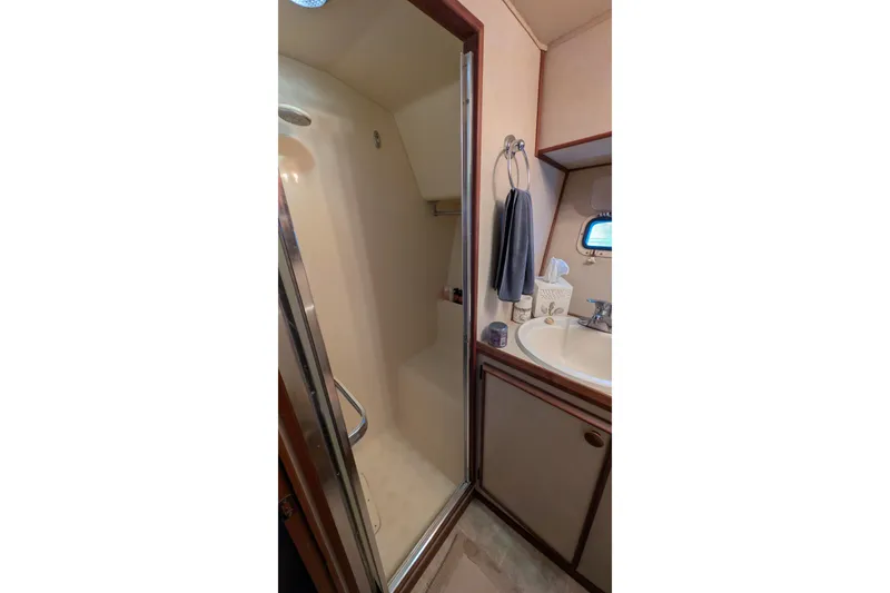 Slide: The Image of 1984 Chris-Craft 382 Commander bathroom with shower, sink, and towel rack. - 83