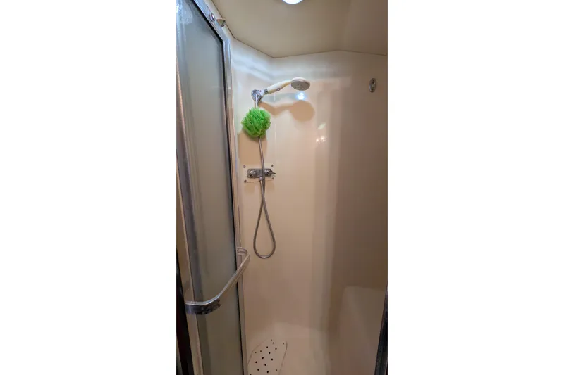 Slide: The Image of Shower area in 1984 Chris-Craft 382 Commander boat with glass door and showerhead. - 84