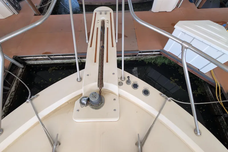 Slide: The Image of 1984 Chris-Craft 382 Commander boat deck with anchor chain and railing. - 90