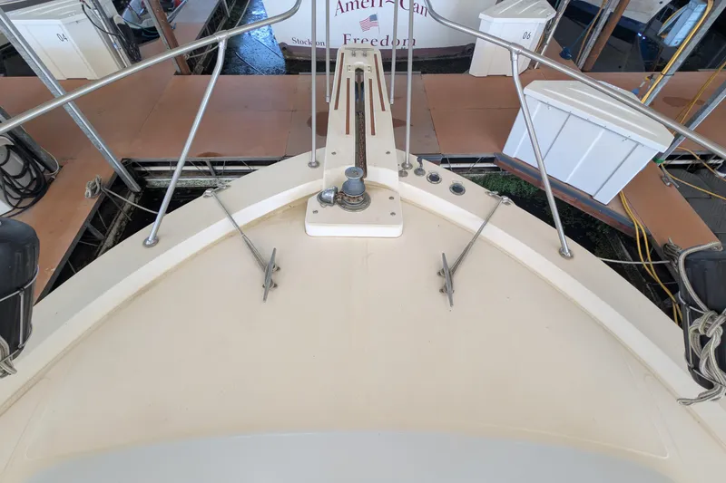 Slide: The Image of 1984 Chris-Craft 382 Commander boat deck with anchor and railing at dock. - 94