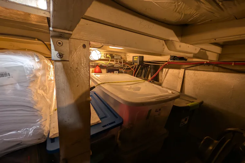 Slide: The Image of Storage area inside 1984 Chris-Craft 382 Commander boat with containers and wiring. - 97
