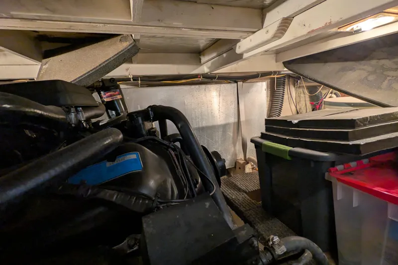 Slide: The Image of Engine room of 1984 Chris-Craft 382 Commander with visible storage containers. - 98