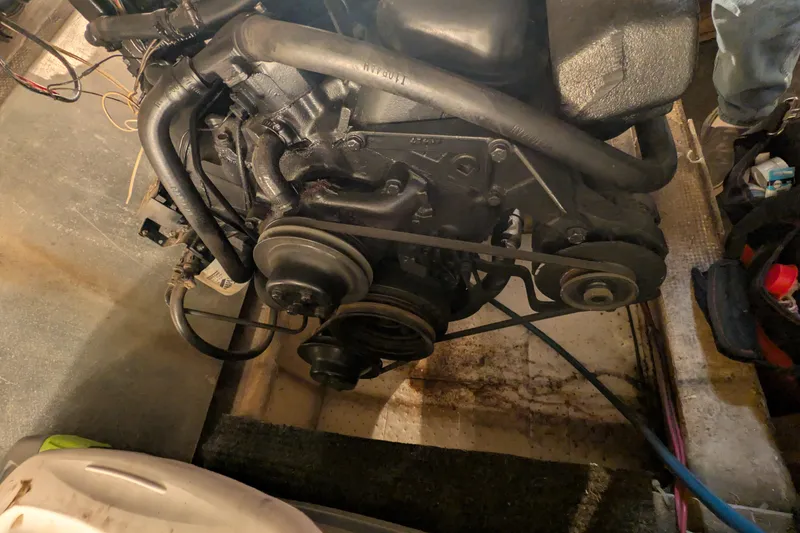 Slide: The Image of Engine of a 1984 Chris-Craft 382 Commander boat, showcasing belts and hoses. - 99