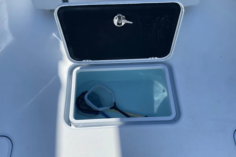 Slide: The Image of Open storage compartment on 2022 Conch 33 boat with fishing net inside. - 13