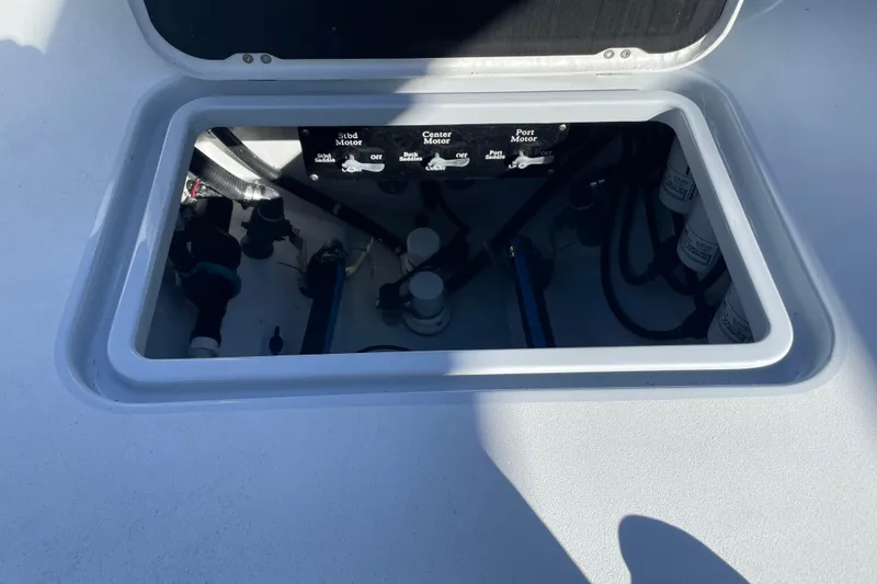 Slide: The Image of Open hatch of 2022 Conch 33 boat showing engine controls and components. - 14