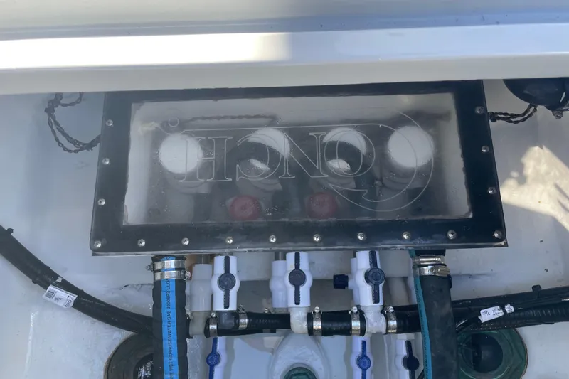 Slide: The Image of Engine compartment of 2022 Conch 33 boat with visible hoses and fittings. - 15