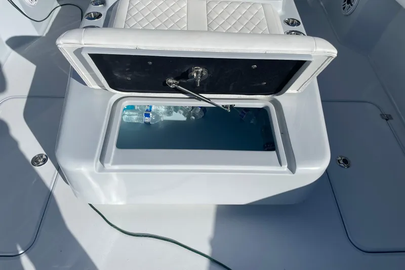 Slide: The Image of Open storage compartment on 2022 Conch 33 boat with water bottles inside. - 20