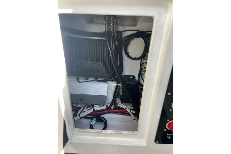 Slide: The Image of 2022 Conch 33 boat electronics compartment with Garmin equipment and wiring. - 21