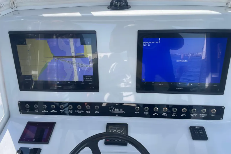 Slide: The Image of Control panel of a 2022 Conch 33 boat with dual Garmin displays. - 8