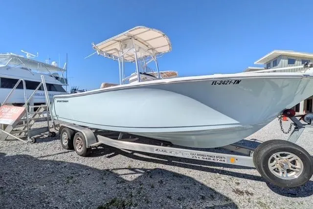 The Image of 2020 Sportsman Open 232 Center Console boat on trailer, parked outdoors. - 0