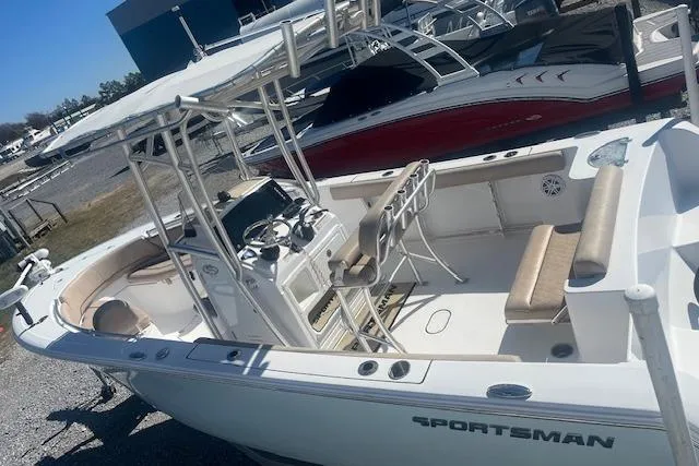 Slide: The Image of 2020 Sportsman Open 232 Center Console boat with seating and control panel, docked outdoors. - 3