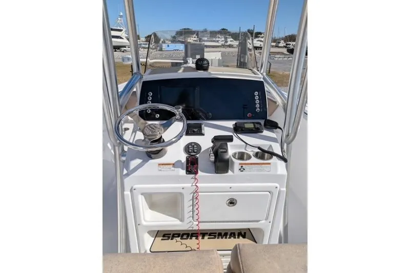 Slide: The Image of 2020 Sportsman Open 232 Center Console boat dashboard with steering wheel and controls. - 8