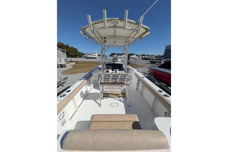 Slide: The Image of 2020 Sportsman Open 232 Center Console boat with T-top, docked under clear blue sky. - 9