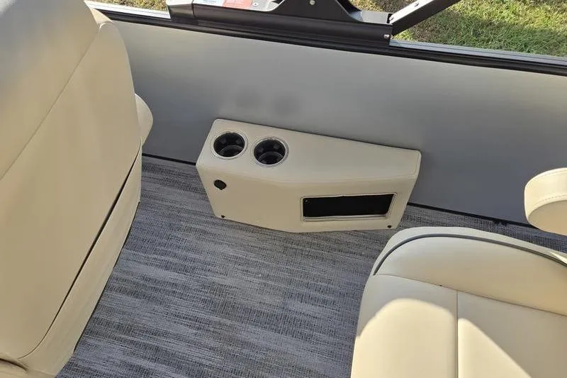 Slide: The Image of Interior of 2025 Godfrey Sweetwater 2286 QS with beige seating and cup holders. - 16