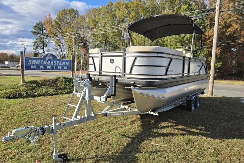 The Image of 2025 Godfrey Sweetwater 2286 QS pontoon boat on trailer at Southeastern Marine dealership. - 0