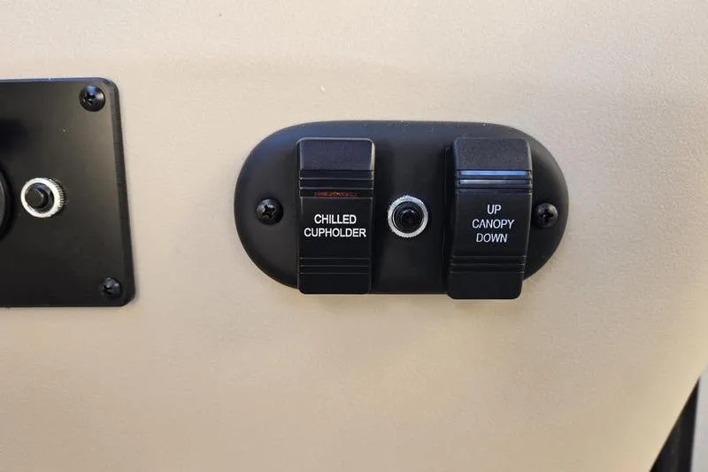 Slide: The Image of Control panel with chilled cupholder and canopy switches on 2025 Godfrey Sweetwater 2286 QS. - 12