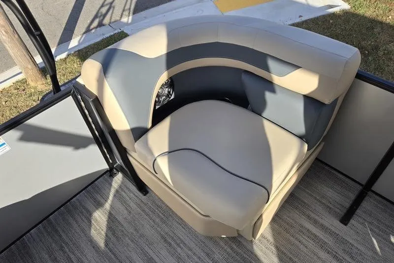 Slide: The Image of 2025 Godfrey Sweetwater 2286 QS boat seating, featuring beige and blue cushioned corner seat. - 13