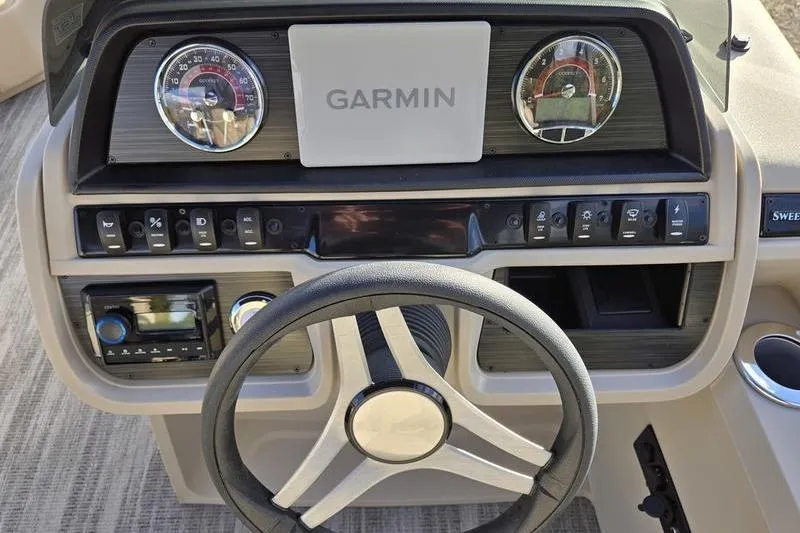 Slide: The Image of 2025 Godfrey Sweetwater 2286 QS dashboard with Garmin display and steering wheel. - 14