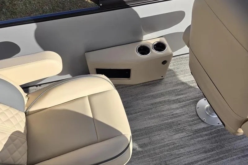 Slide: The Image of 2025 Godfrey Sweetwater 2286 QS interior with beige seating and cup holders. - 18