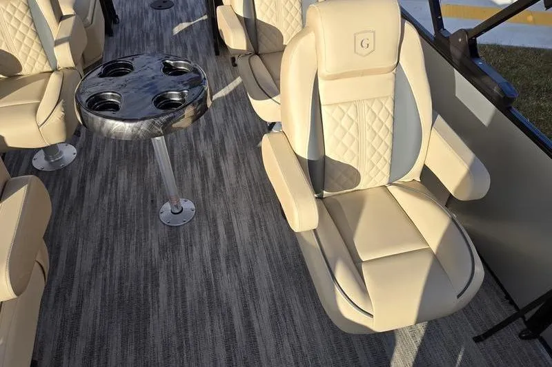 Slide: The Image of Luxurious seating on 2025 Godfrey Sweetwater 2286 QS pontoon boat with stylish table. - 4