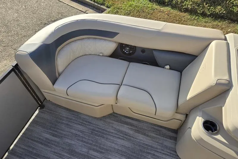 Slide: The Image of Luxurious seating on 2025 Godfrey Sweetwater 2286 QS pontoon boat, featuring plush beige upholstery. - 7