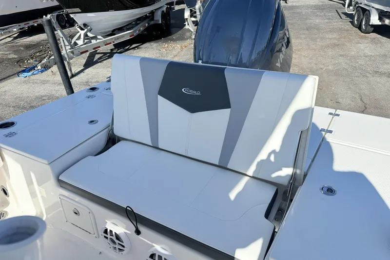 Slide: The Image of 2023 Robalo 226 Cayman boat interior with cushioned seating and Yamaha engine. - 8