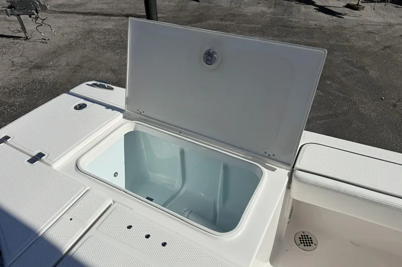 Slide: The Image of 2023 Robalo 226 Cayman boat storage compartment open on deck. - 9