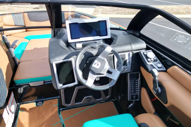 Slide: The Image of 2023 Malibu M220 boat interior with modern dashboard and touchscreen controls. - 11