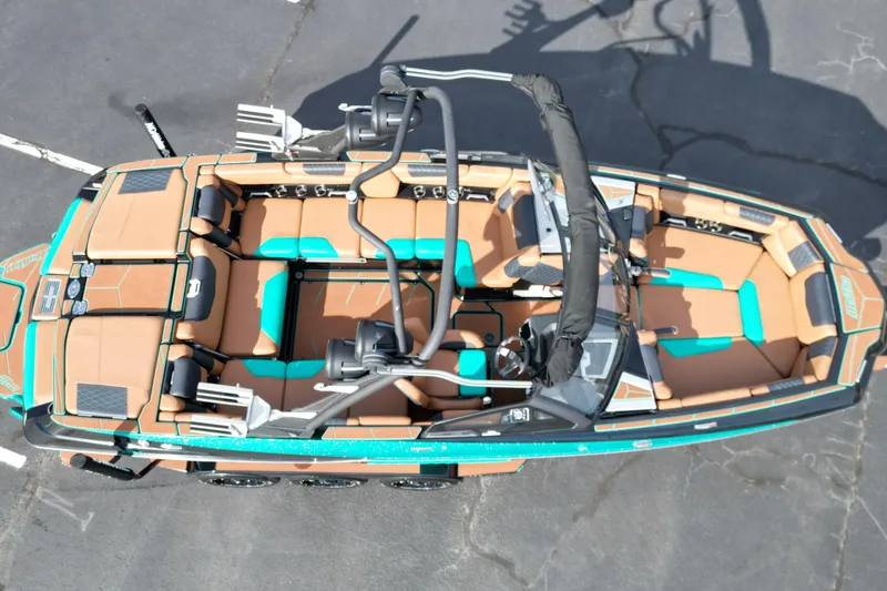 Slide: The Image of 2023 Malibu M220 boat interior with brown and teal seating, aerial view. - 14