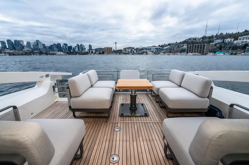 Slide: The Image of Luxurious 2026 Absolute 48 Coupe yacht deck with city skyline view. - 15