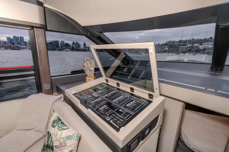 Slide: The Image of Interior view of 2026 Absolute 48 Coupe yacht with control panel and cityscape. - 21