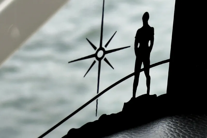 Slide: The Image of Silhouette of a person and compass on Absolute 48 Coupe 2026 yacht. - 23