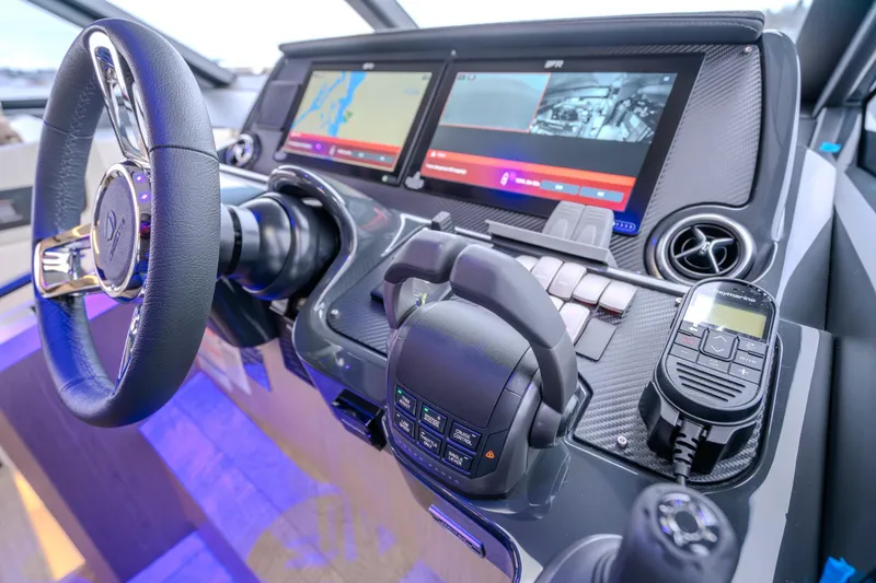 Slide: The Image of Cockpit of 2026 Absolute 48 Coupe with advanced navigation and control systems. - 26