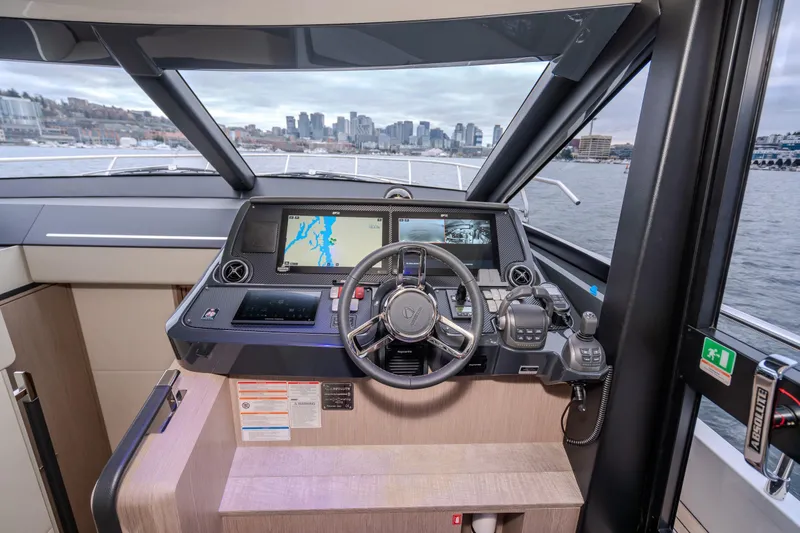 Slide: The Image of Helm of 2026 Absolute 48 Coupe yacht with navigation screens and city skyline view. - 28