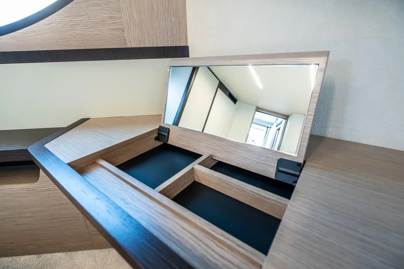 Slide: The Image of Interior of 2026 Absolute 48 Coupe with sleek wooden vanity and mirror. - 40