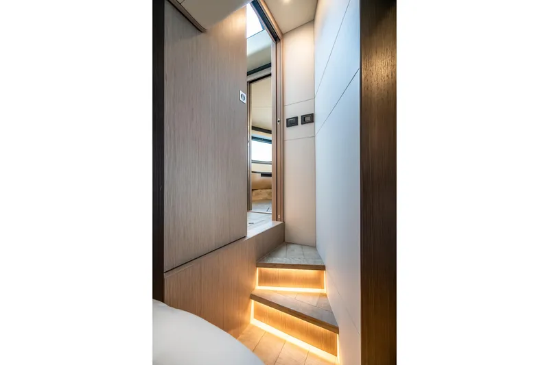 Slide: The Image of Interior of 2026 Absolute 48 Coupe yacht with illuminated wooden stairs. - 44
