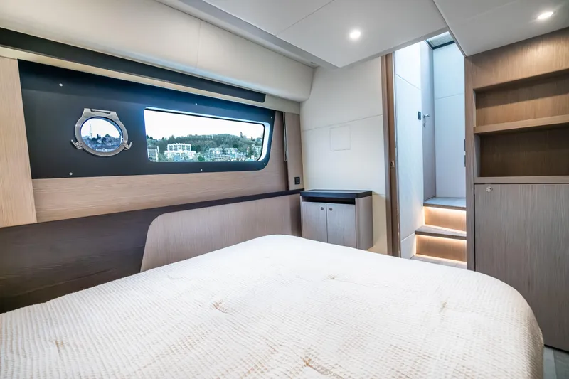 Slide: The Image of Luxurious interior of 2026 Absolute 48 Coupe yacht with modern design and scenic window view. - 46
