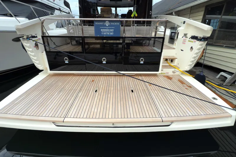 Slide: The Image of 2026 Absolute 48 Coupe yacht with teak deck at marina. - 50