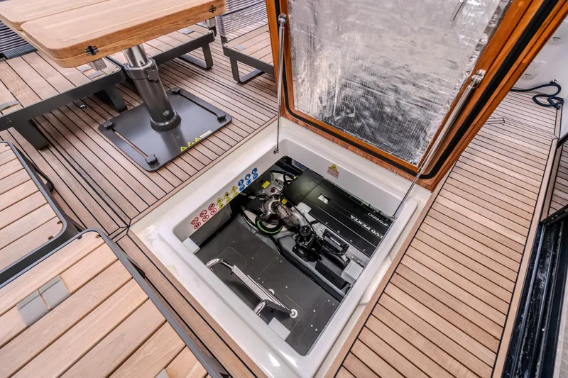 Slide: The Image of Engine compartment of 2026 Absolute 48 Coupe yacht with open hatch on teak deck. - 51