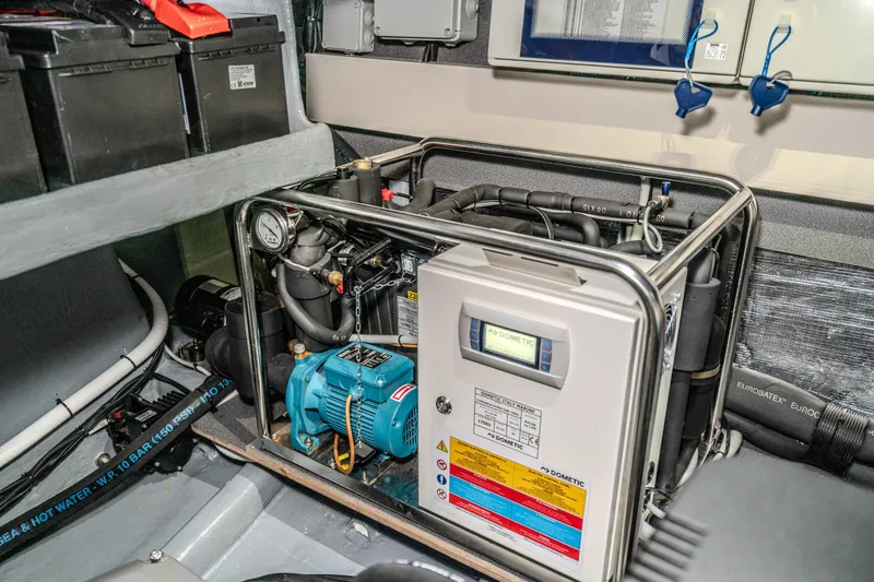 Slide: The Image of Engine room of 2026 Absolute 48 Coupe with advanced machinery and equipment. - 57