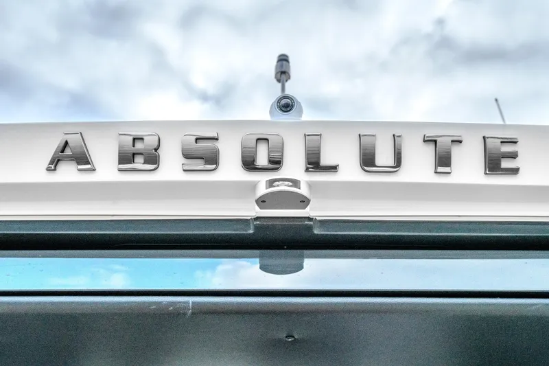 Slide: The Image of Absolute 48 Coupe 2026 logo on a sleek, modern yacht exterior. - 62