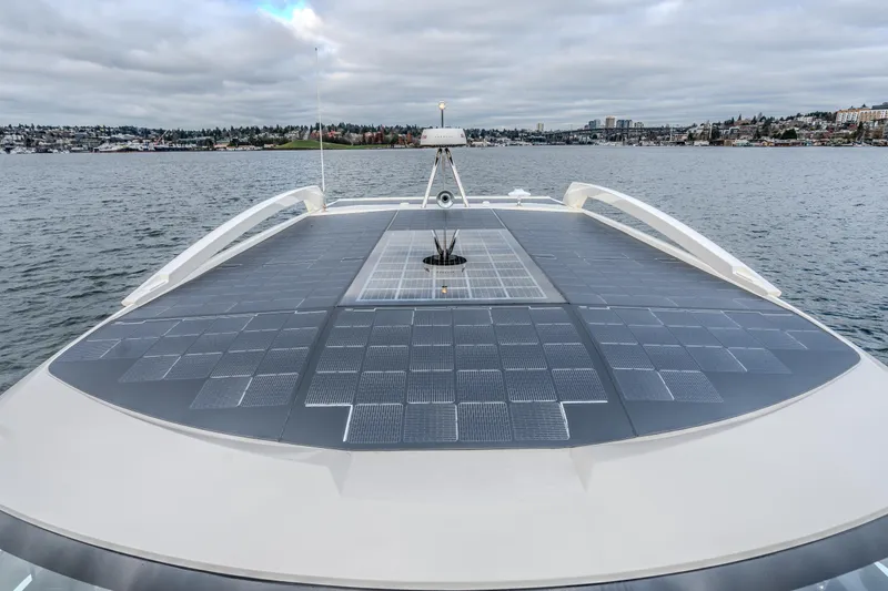 Slide: The Image of 2026 Absolute 48 Coupe yacht with solar panels on deck, cruising on a calm lake. - 8