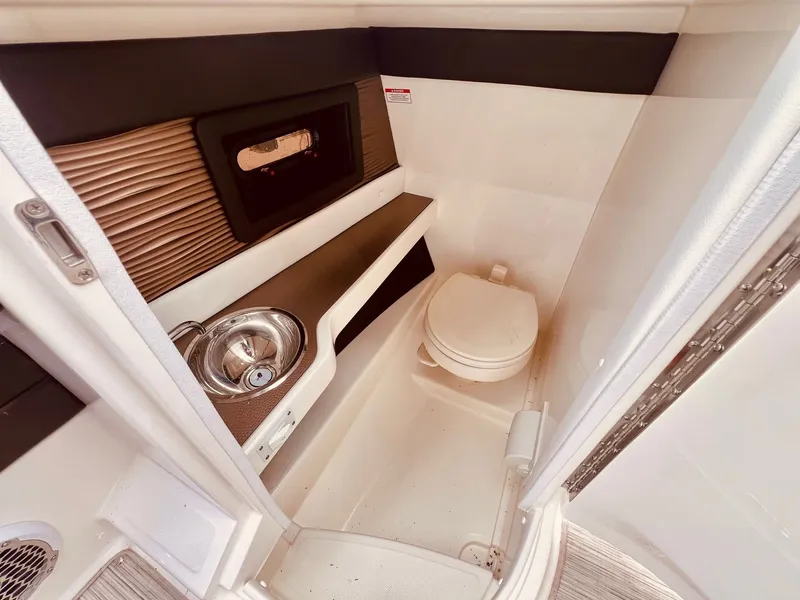 Slide: The Image of Interior of 2017 Sea Ray SLX 250 yacht with toilet and sink. - 25