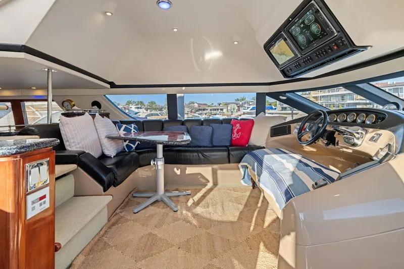 Slide: The Image of Luxurious interior of a 1999 Carver 53 Voyager yacht with plush seating and modern dashboard. - 10