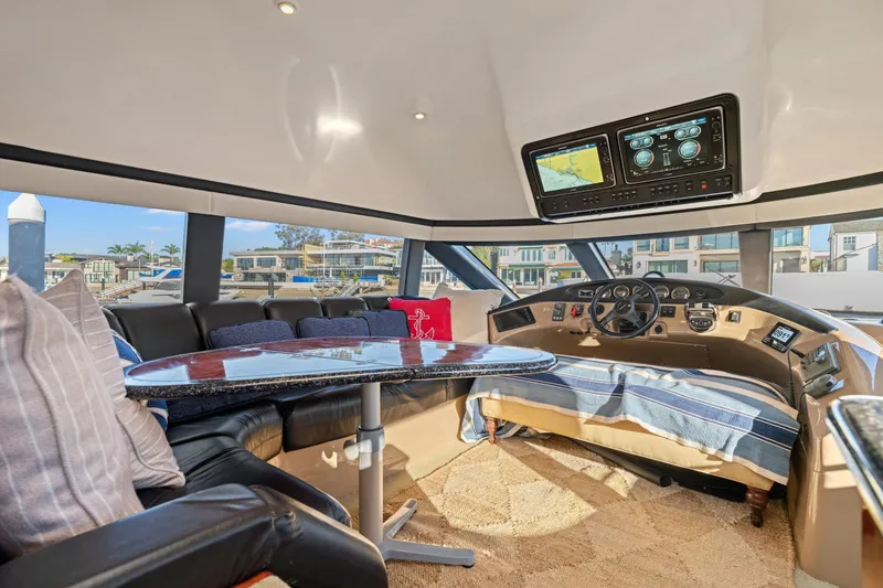 Slide: The Image of Luxurious interior of a 1999 Carver 53 Voyager yacht with helm and seating area. - 11