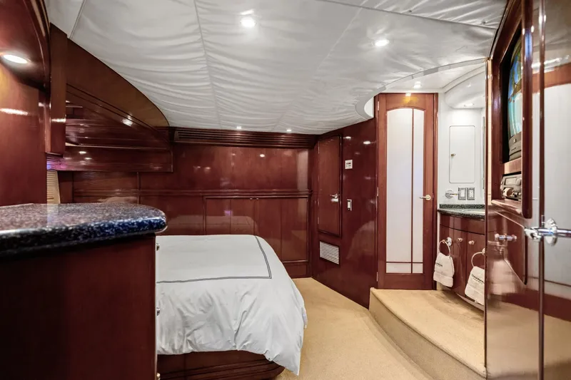 Slide: The Image of Luxurious interior of 1999 Carver 53 Voyager yacht with elegant wood finishes and cozy bedroom. - 18
